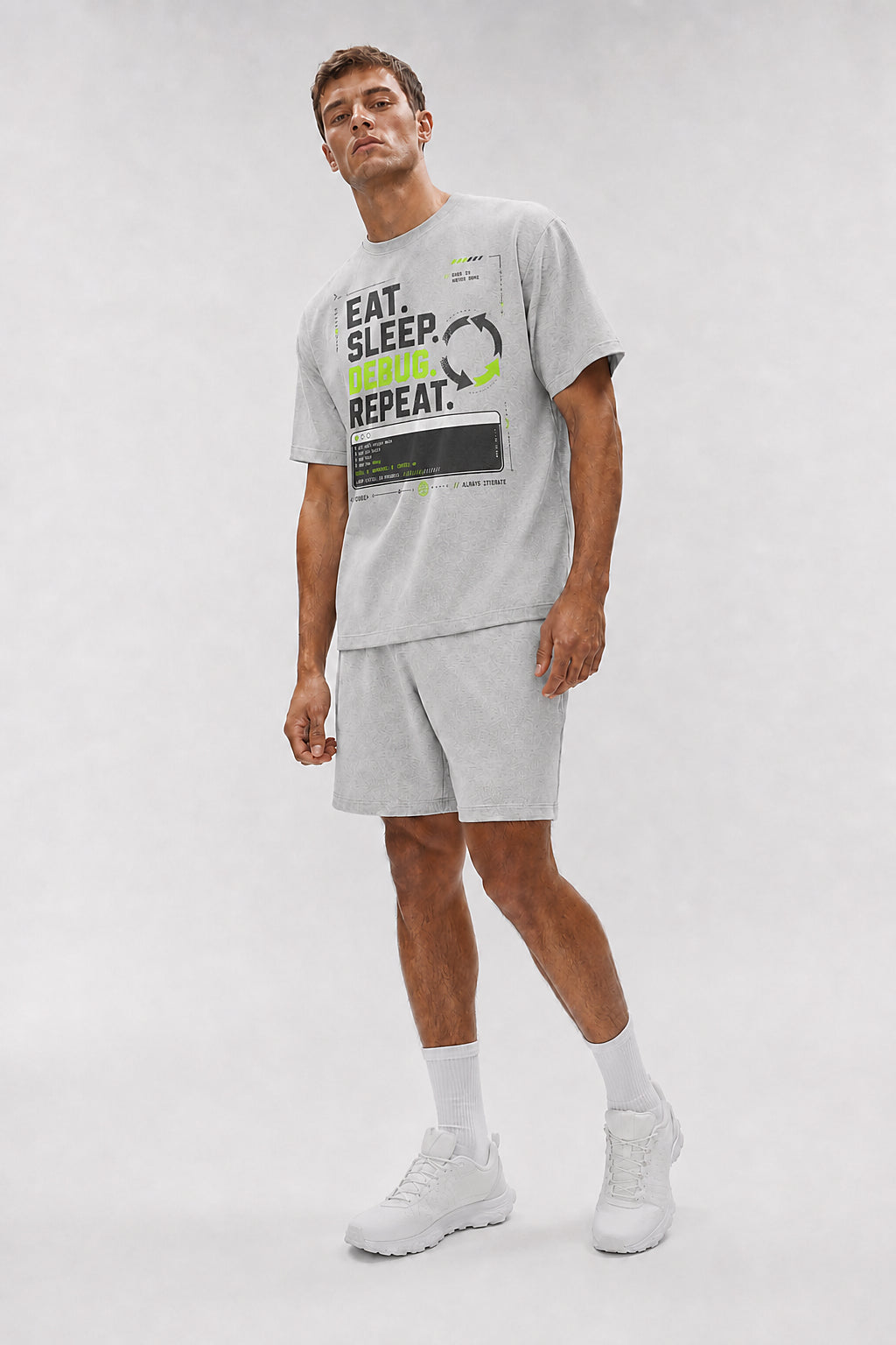 Uncropped full-body view of a model wearing the Athletic Heather Eat. Sleep. Debug. Repeat. oversized boxy tee.