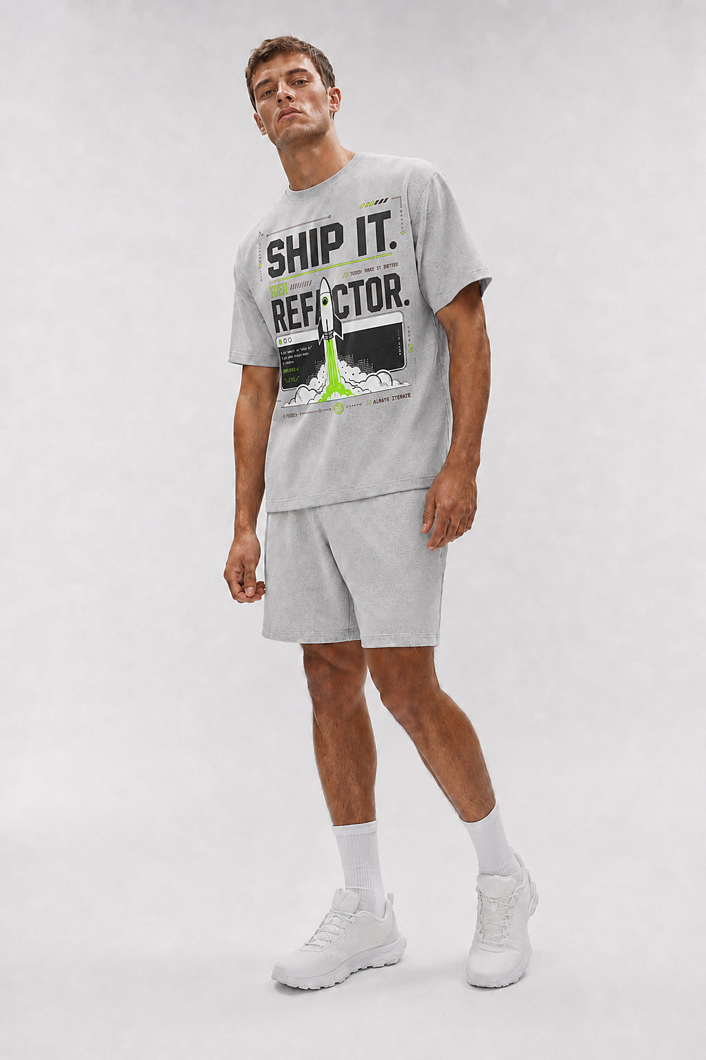 Uncropped full-body view of a model wearing the Athletic Heather Ship It. Then Refactor. oversized boxy tee.
