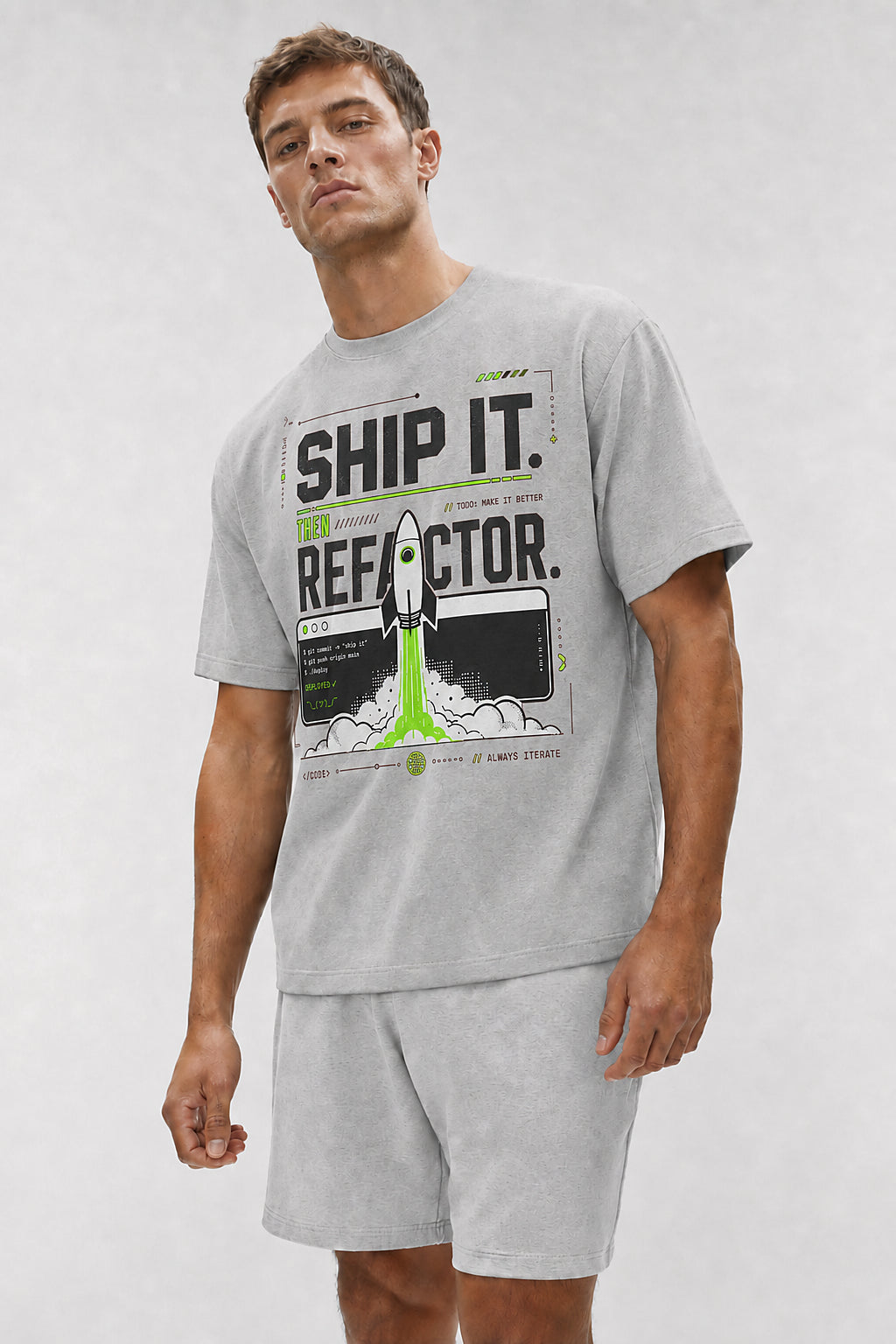 Head-safe close-up of a model wearing the Athletic Heather Ship It. Then Refactor. oversized boxy tee.