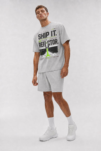 Uncropped full-body view of a model wearing the Athletic Heather Ship It. Then Refactor. oversized boxy tee.