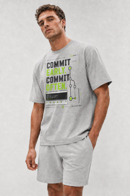Head-safe close-up of a model wearing the Athletic Heather Commit Early. Commit Often. oversized boxy tee.