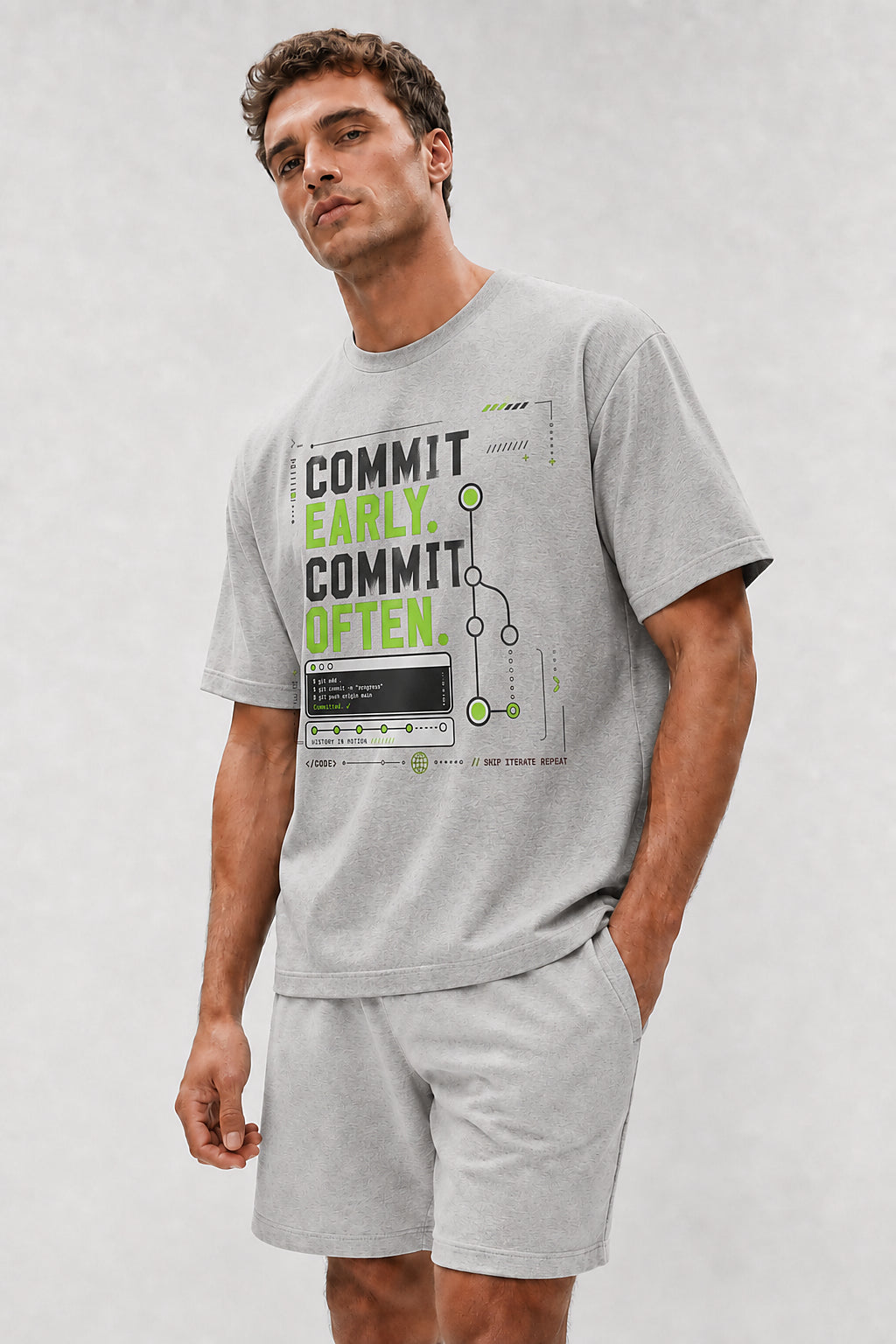 Head-safe close-up of a model wearing the Athletic Heather Commit Early. Commit Often. oversized boxy tee.