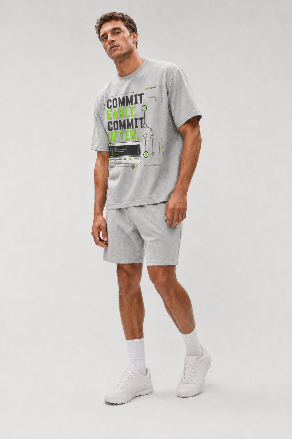 Uncropped full-body view of a model wearing the Athletic Heather Commit Early. Commit Often. oversized boxy tee.
