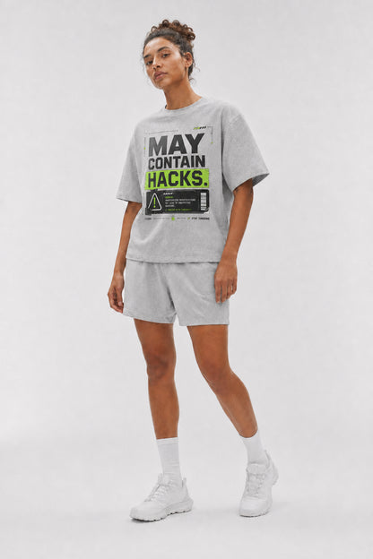 Uncropped full-body view of a model wearing the Athletic Heather May Contain Hacks oversized boxy tee.