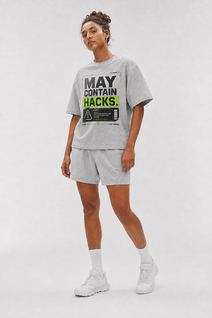 Uncropped full-body view of a model wearing the Athletic Heather May Contain Hacks oversized boxy tee.