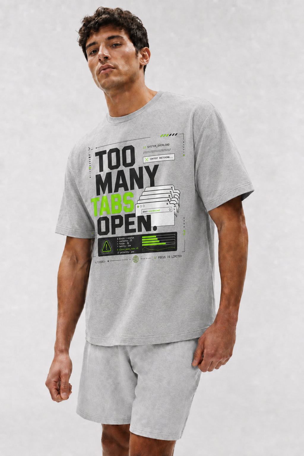 Head-safe close-up of a model wearing the Athletic Heather Too Many Tabs Open oversized boxy tee.